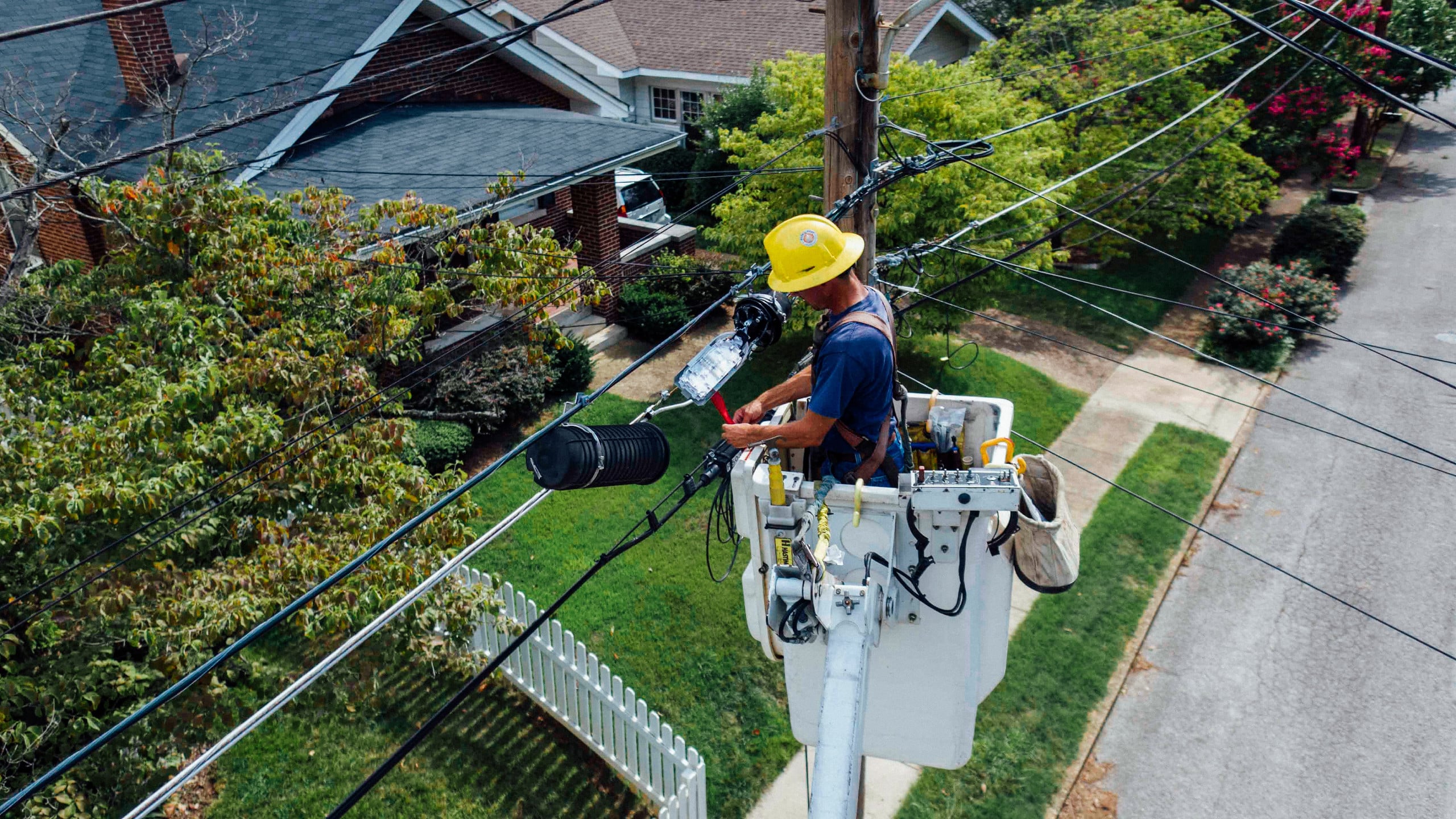 Photo of an electrician working on a power line