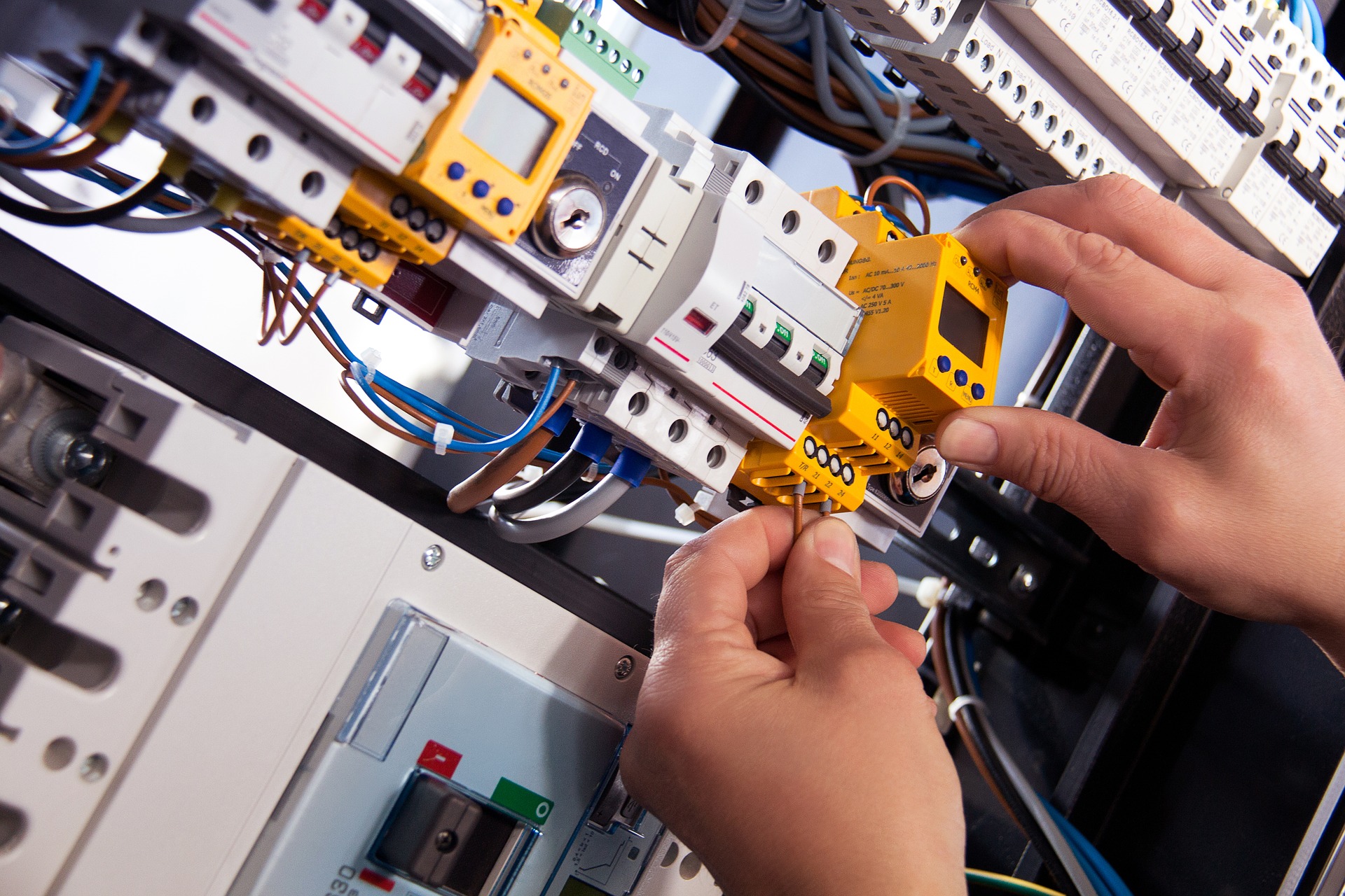 photo of an electrician checking a complicated electrical panel