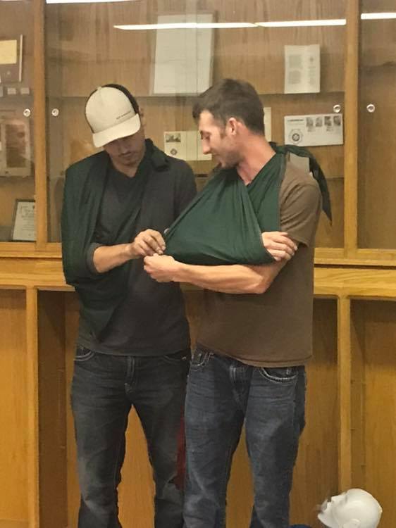 electricians learning to support injured arm with a sling