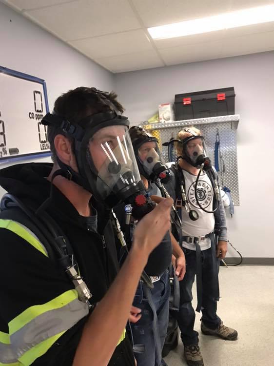 photo of Schultz Electric electricians training to use breathing aparatus