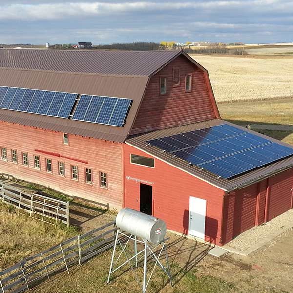 photo of an old barn retrofit with solar panels on the roof