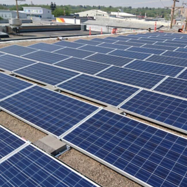 photo of a warehouse with solar panels on the roof