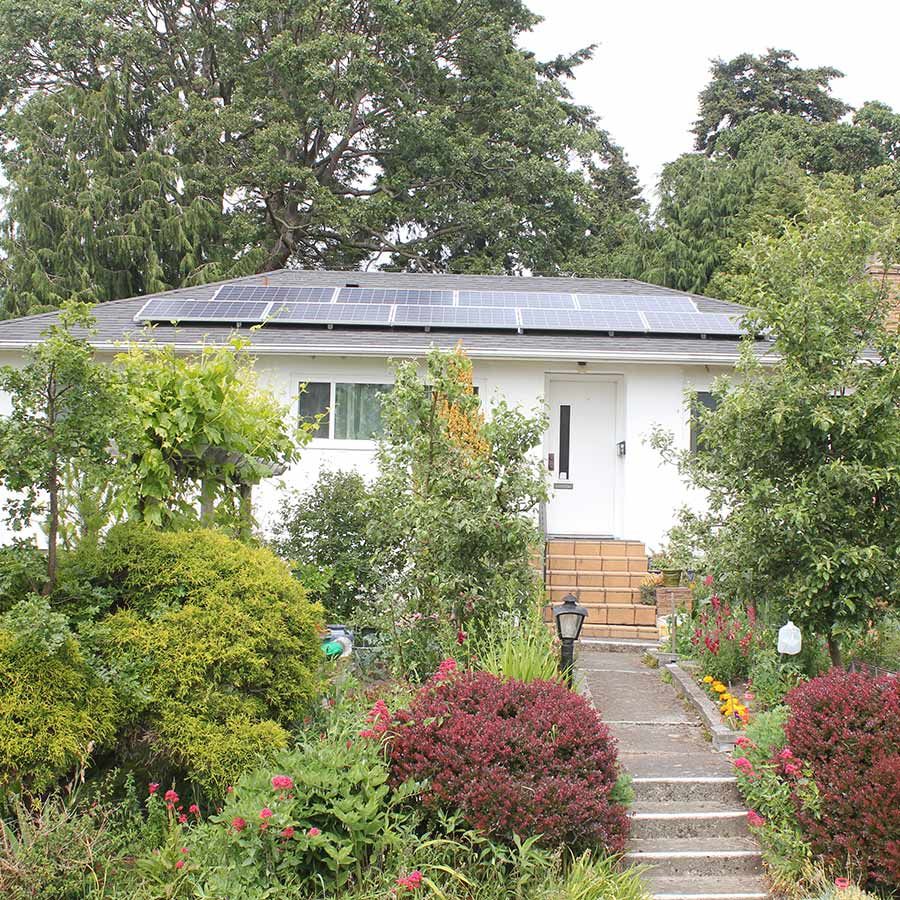 photo of a home with solar panels on the roof